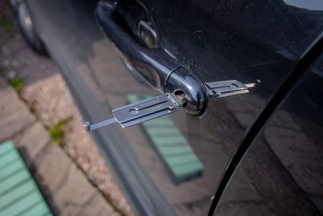 Close-up of a locksmith tool inserted into a car door lock, demonstrating security access. Track locksmith trends in your own service-call mix